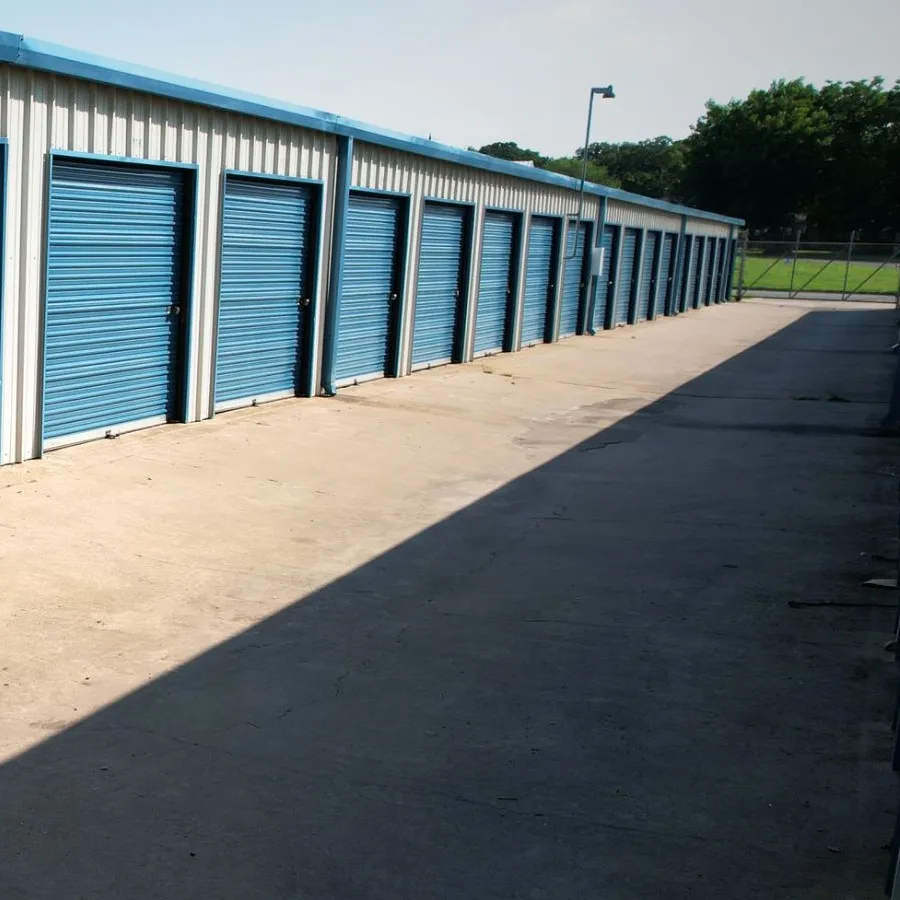 Ground-level view of drive-up storage units with blue doors